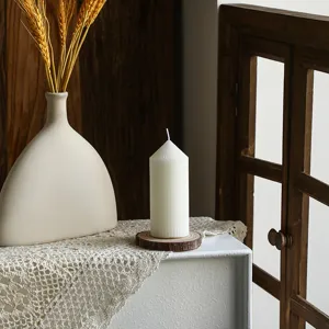 Nordic white striped pointed pillar candle detail shot, elegant scented home decor candle.