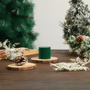 Green ribbed cylinder scented soy candle detail, ideal for Christmas holiday decor and cozy setups.