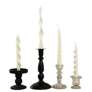 White spiral taper scented candles with various metal and glass holders for dinner decor.