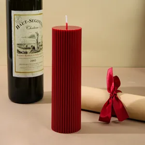 Red ribbed pillar scented candle for home decor, cozy atmosphere setup, and romantic gifts.
