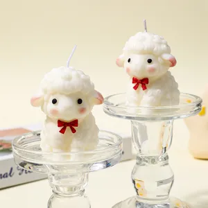 Close-up view of cute little sheep soy wax candles with red bow, perfect home decor detail.