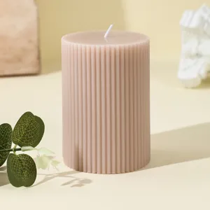 Ribbed cylindrical scented soy wax candle, detailed close-up shot showing textured surface.