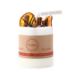 Botanical scented soy wax candle decorated with orange slices and cinnamon for cozy home decor.