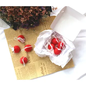 Mini strawberry scented candles detail view, cute handmade wax decor for wedding gifts.