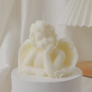 White angel scented soy wax candle, delicate cupid sculpture design for home decor and photography.