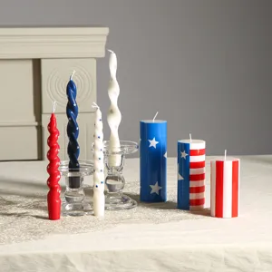 Patriotic decorative candles set with red white blue stars and stripes for home holiday decor.