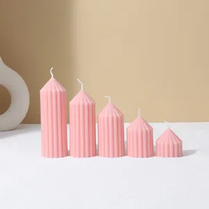 Close up of pink striped pointy pillar scented candles set, minimalist home decor props.