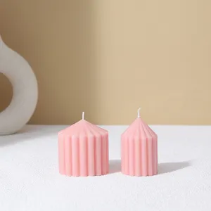 Detailed view of pink ribbed conical scented candles, minimalist home decor aesthetic.