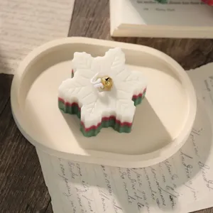 Christmas snowflake scented soy wax candle with red green layers and bell decor for holiday gift.