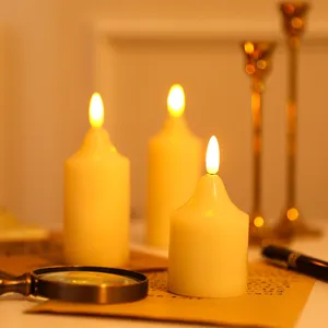 Close-up detail of warm glowing LED electronic candles on a cozy tabletop decor scene.