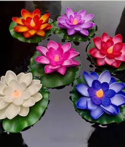 Nahaufnahme von bunten schwimmenden Lotus LED Kerzen, die anmutig auf dem Wasser leuchten.