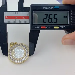 Detail view of round mother of pearl pendant with cubic zirconia, measured at 26.5mm size.