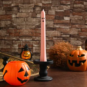 Detailed view of the cute pink ghost long pillar candle with spooky Halloween atmosphere props.