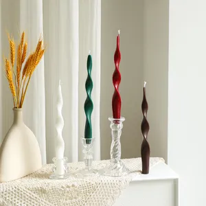 Detailed view of handmade twisted taper scented soy candles in assorted colors for home decor.