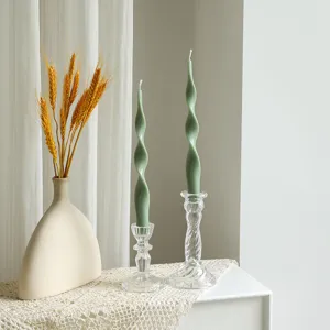 Twisted taper scented soy wax candle in glass holder for home decor and cozy ambiance.