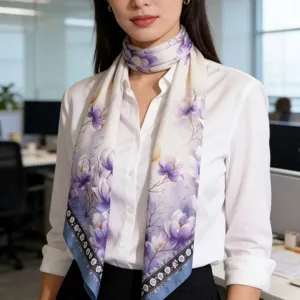 Elegant floral print silk scarf detail, lightweight fabric draped gracefully on model in office.