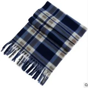 Close-up view of the cozy blue plaid winter scarf featuring soft fabric and delicate fringes.