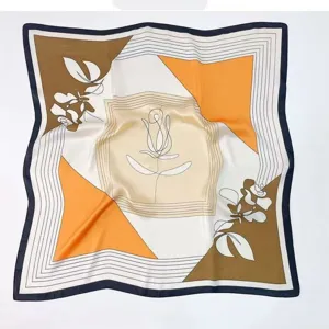 Detailed view of the elegant square silk scarf featuring chic geometric and floral line art.