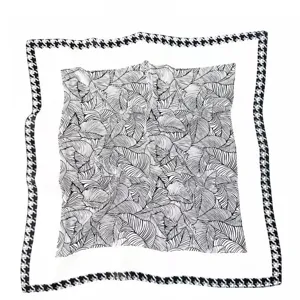 Chic black and white leaf print square silk scarf with classic houndstooth border design.