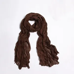 Dark brown crinkled solid color scarf voile hijab shawl detail view, lightweight texture.