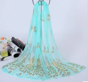 Lightweight turquoise chiffon scarf featuring elegant gold foil peacock feather print beach wrap.