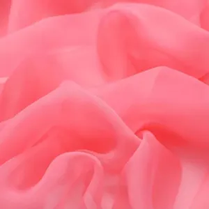 Close-up of pink lightweight soft sheer chiffon fabric scarf, delicate texture drape and smooth.