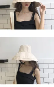 Close-up detail shot of a beige bucket hat with a wide brim, showcasing daily fashion wear style.