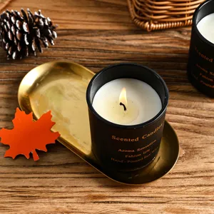 Vintage black scented candle in glass jar with gold tray for home decor and romantic fragrance.