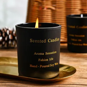 Detailed view of a black scented candle made with soy wax in a stylish glass jar.