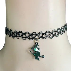 Close-up view of black tattoo choker necklace with cute witch pendant for Halloween.