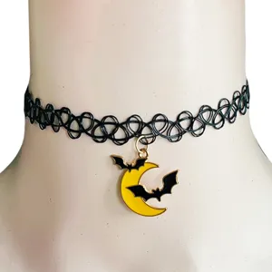 Halloween black choker necklace close up, featuring a yellow moon and bat pendant detail.