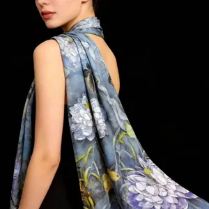 Detailed view of women elegant blue floral silk scarf shawl, soft lightweight long design.