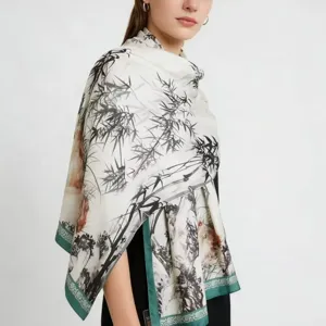 Detailed view of the elegant printed silk scarf featuring black bamboo and green border.