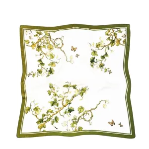 Detail view of vintage botanical silk scarf with green border and butterfly print for women.