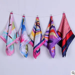 Detailed view of colorful printed square scarves featuring vibrant geometric and floral patterns.