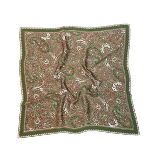 Detailed view of vintage paisley print square silk scarf, elegant green and red floral pattern.
