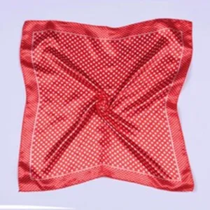 Red silk square scarf detail, elegant polka dot pattern with border, fashion accessory.