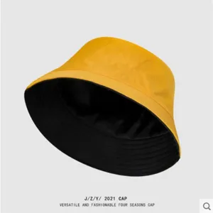 Classic reversible bucket hat for men and women, stylish solid color sun protection cap.