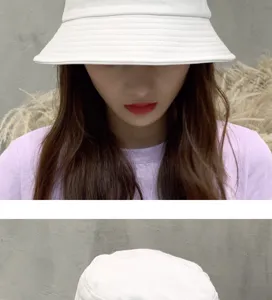 White cotton bucket hat detail close-up view, casual sun protection basin hat design.