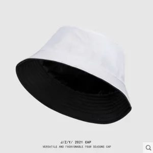 Detailed view of reversible black and white bucket hat, simple solid color everyday wear.