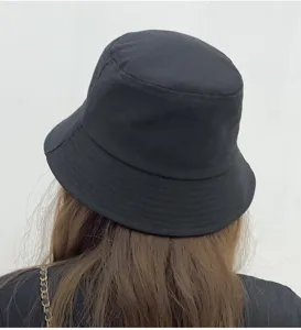 Detail view of a classic black cotton bucket hat worn from the back, offering a stylish look.