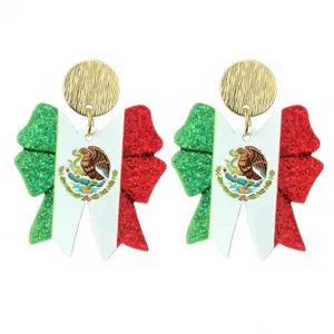 Close-up detail of Mexican flag bow earrings with gold textured studs for world cup fans.