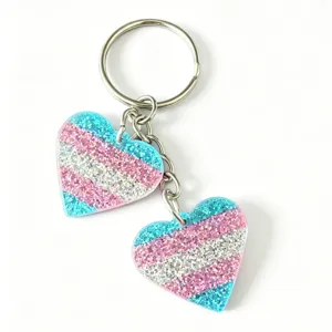 Glitter heart keychain detail, sparkling double heart pendant with metal ring, cute accessory.