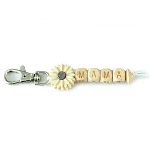 Close-up detail of the MAMA wooden bead sunflower keychain with metal clasp and cord.