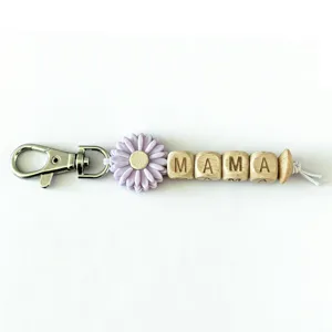 Mother's Day gift keychain with silicone sunflower bead and wooden letter blocks spelling MAMA.
