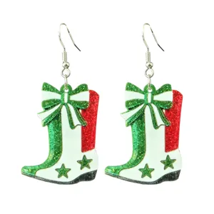 Glittering Christmas cowboy boot earrings with green bow and star details for women.