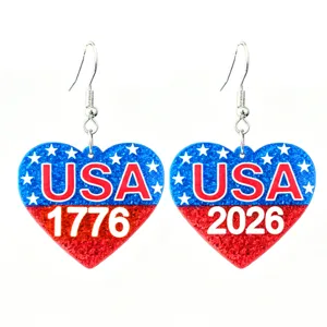 Closeup detail of USA 1776-2026 patriotic heart dangle earrings with sparkly red blue resin.