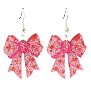 Vue détaillée de boucles d'oreilles nœud pailleté rose bijoux mode femme tendance fête.