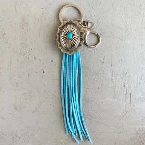 Vintage western style keychain with turquoise stone and blue suede fringe for bags.