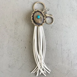 Vintage Western style concho keychain with turquoise stone and long white leather fringe.